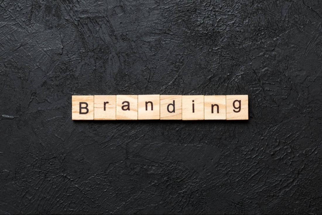 Wooden letter tiles spelling the word Branding on a dark background